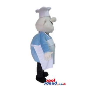 Chef wearing a white chef's hat and apron, a light-blue