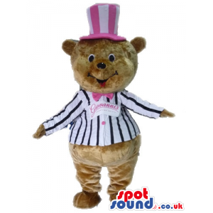 Brown bear wearing a striped black and white jacket and a