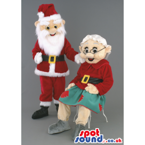 Grandmother And Santa Claus Mascots With Green And Red Garments