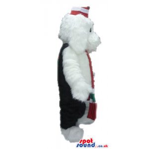 White dog wearing a red, green and white scarf, black trousers