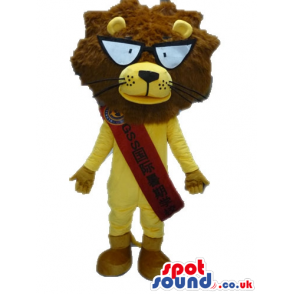 Yellow lion with a furry brown head, big round eyes, beige feet