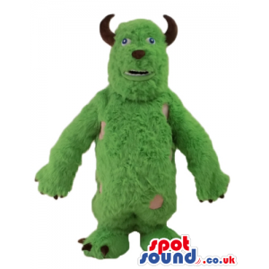 Green furry monster with small eyes and small brown horns -