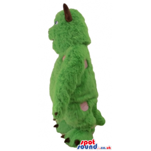 Green furry monster with small eyes and small brown horns -