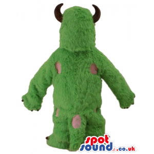 Green furry monster with small eyes and small brown horns -