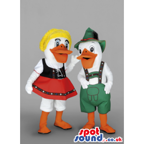 A Couple Of Ducks In Tirol Dresses With Red Skirt, Green Hat -
