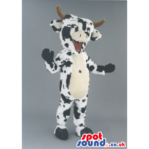 Black And White Cow Animal Mascot With Horns And A Happy Smile