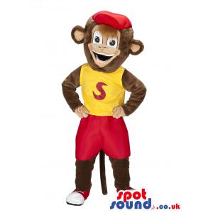 Monkey mascot with red shorts and red cap and in a yellow