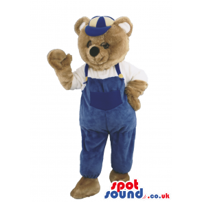 Brown Bear Animal Mascot Wearing Blue Overalls And A Cap -