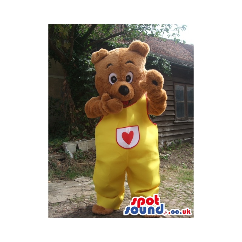 Brown Bear Animal Mascot Wearing Yellow Overalls With A Heart -