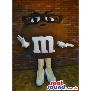 Brown M&M'S Character Mascot Wearing Glasses And High Heels -