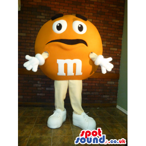 Yellow M&M'S Character Mascot With Funny Face And Sneakers -