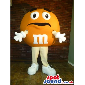 Yellow M&M'S Character Mascot With Funny Face And Sneakers -