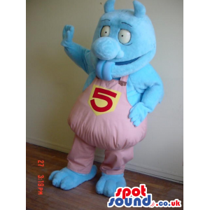 Blue Monster Mascot Wearing Pink Overalls With Number 5 -