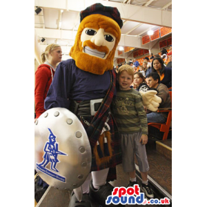 Scottish Human Mascot With Red Beard, Shield And A Kilt -