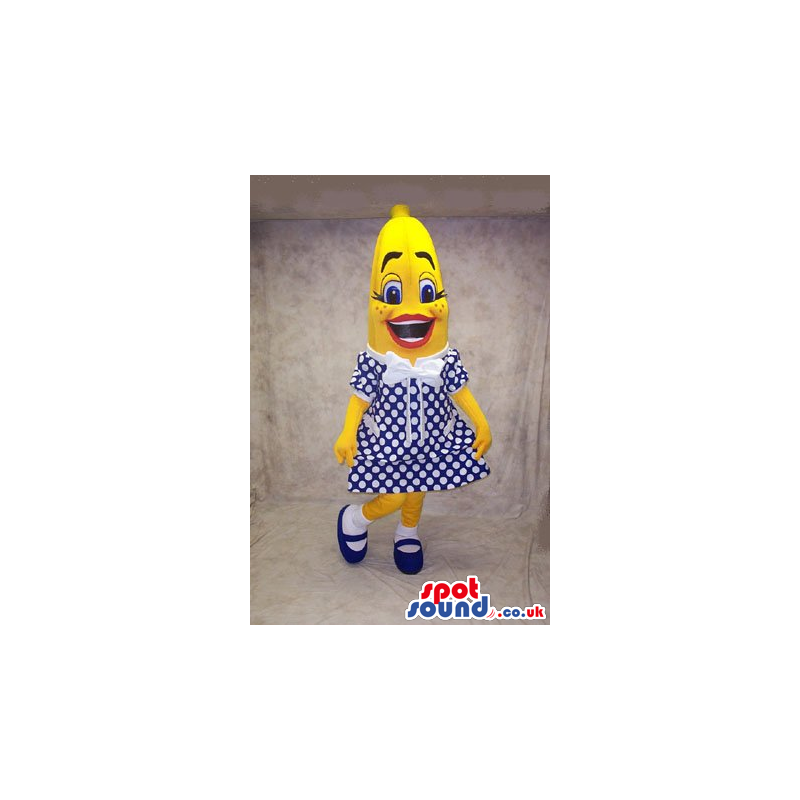 Banana Fruit Mascot Wearing A Polka Dot Dress In Blue And White