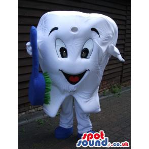Happy teeth mascot with brush in his hands and in white -