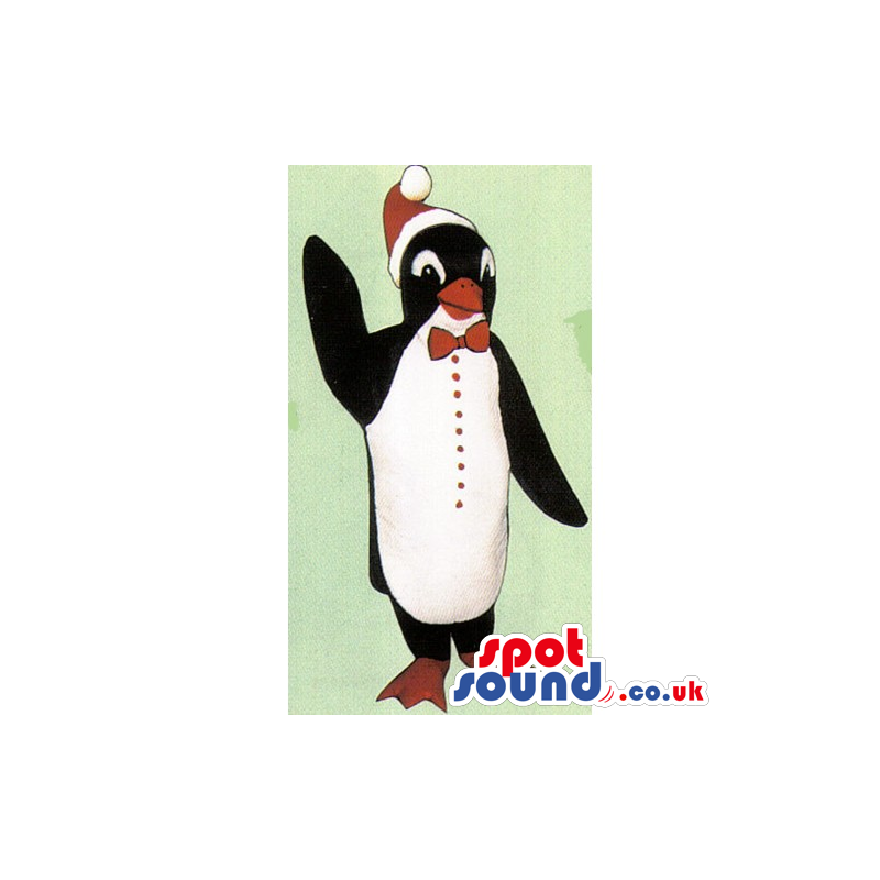 Cute Penguin Mascot Wearing A Christmas Hat And A Bow Tie -