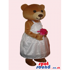 Brown Bear Girl Mascot With Flower Wearing A White Dress -