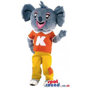 Small elephant mascot with yellow pants and orange t-shirt -