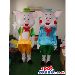 Pig Couple Mascots With Varied Garments In Flashy Colors -