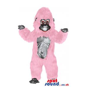 Monkey mascot in pink colour with bare foot looking at you -