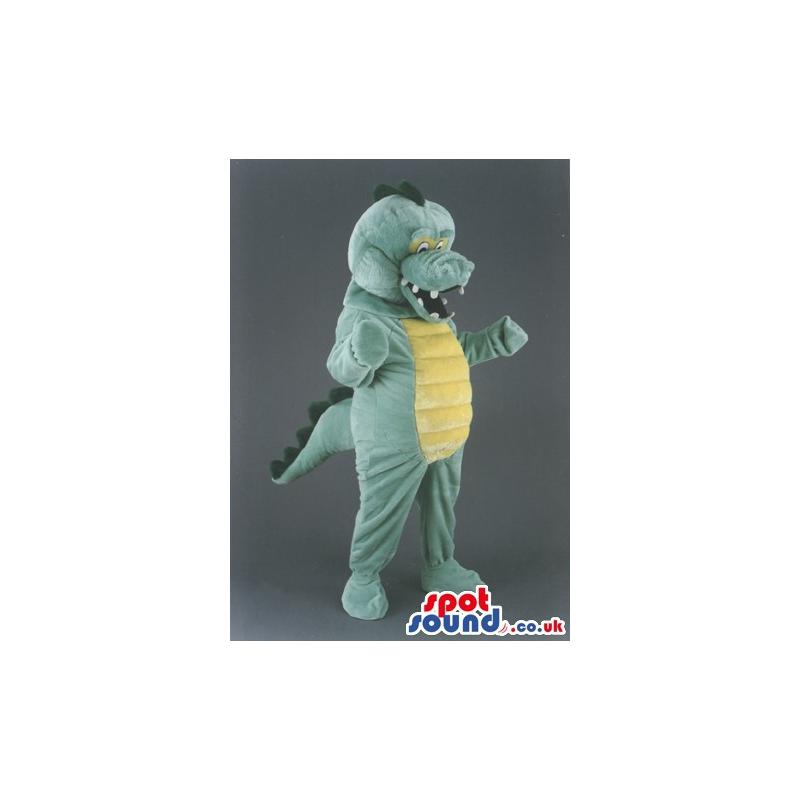 Green and yellow dinosaur mascot with open mouth laughing -