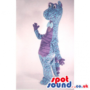 Blue Dinosaur Mascot With Purple Dots Wearing A Bow Tie -