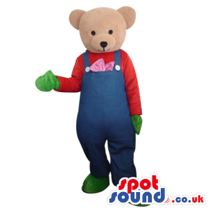 Light Brown Teddy Bear Wearing Blue Overalls And Green Gloves.