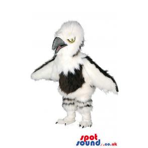 Black and white crow mascot spreading his wings ready to fly -