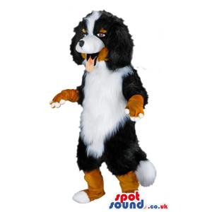 Puppy mascot in black, white and brown with it's tongue out -