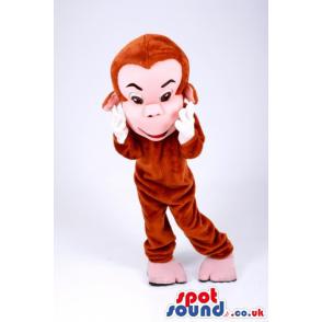 Cute monkey mascot with hands on the cheeks looking happy -