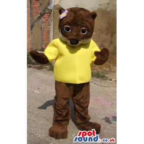 Brown girly bear mascot with a t-shirt and a flower on her head