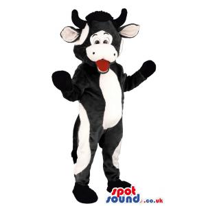 Black and white cow mascot standing and opening his mouth