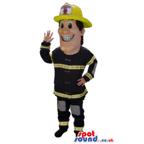 Happy Human Mascot Wearing Black And Yellow Fireman Garments -