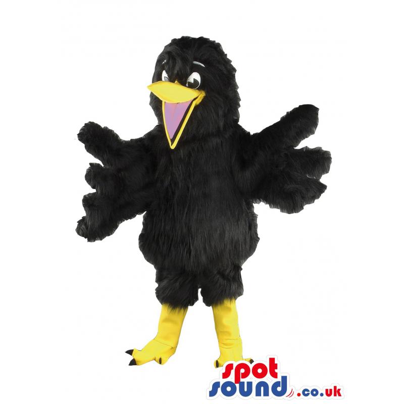 Black crow mascot with his wings wide open and an open mouth -