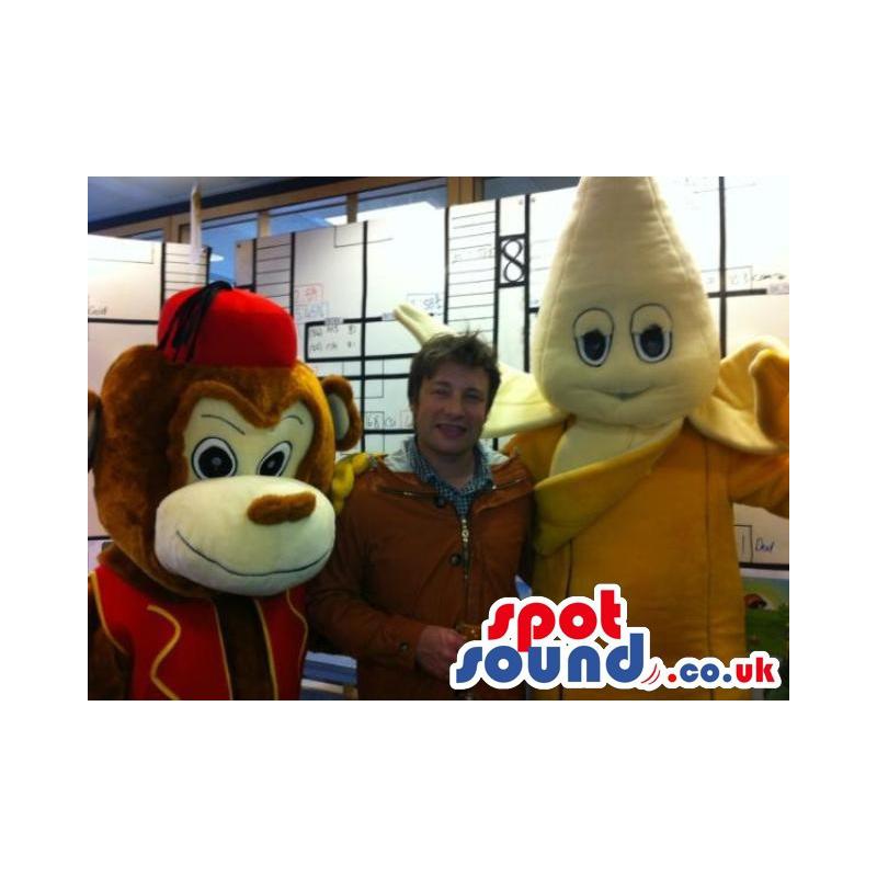 Banana mascot with it's yellow peel costume on with a monkey