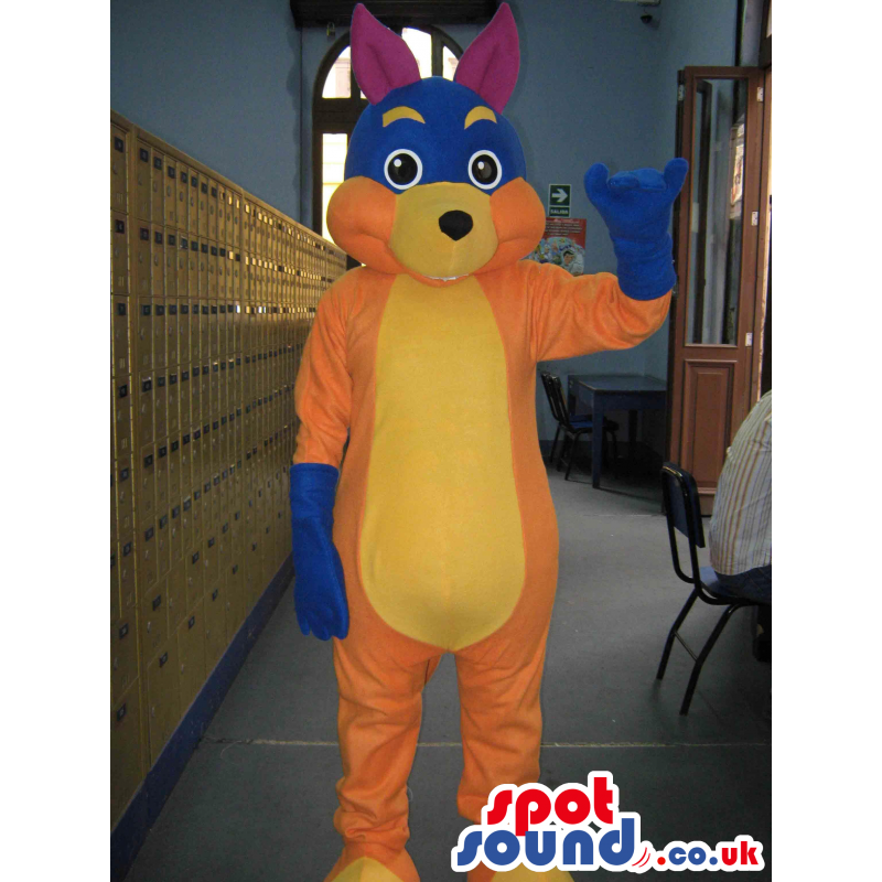 Tall orange rabbit mascot with blue glove and purple ears -