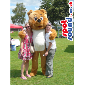 Standing bear mascot with white underbelly and smiling face -