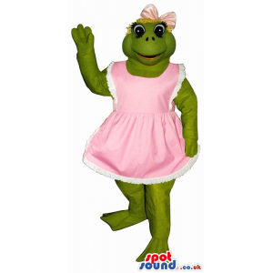 Green Frog Mascot Wearing A Pink Dress Or Apron And A Ribbon -