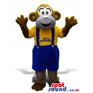 Brown Monkey Plush Mascot Wearing Blue Overalls And T-Shirt -