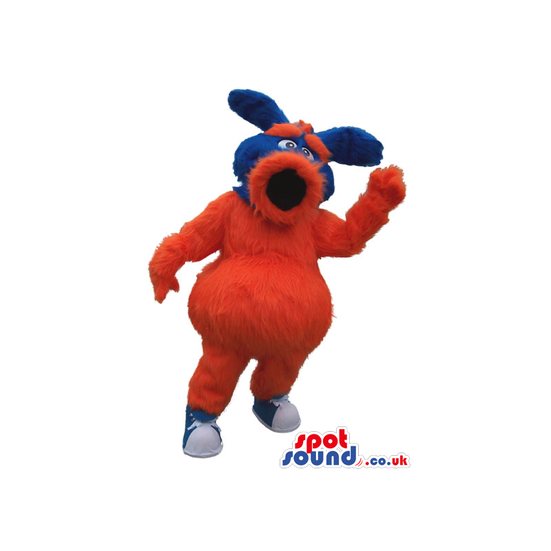 Red And Blue Hairy Mascot With A Big Round Mouth And Ears -