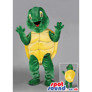 Joyous looking green tortoise with yellow carapace and eyes -