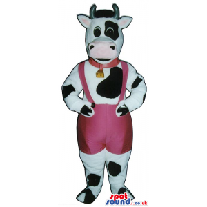White And Black Cow Mascot Wearing Pink Overalls And A Bell -