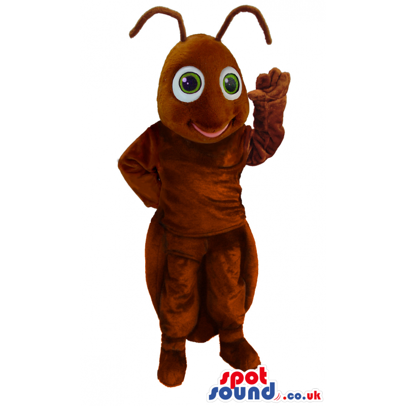 Standing brown, smiling ant mascot with wide round green eyes -