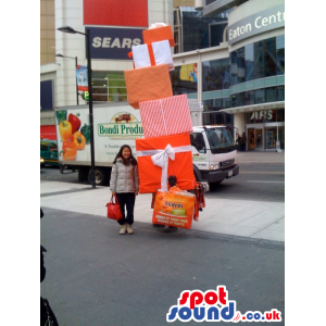 Amazing Stack Of Presents Mascot In Orange And Red - Custom