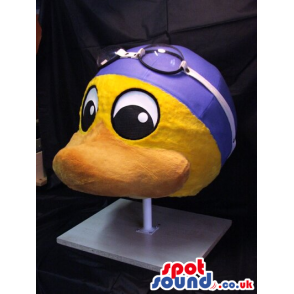 Yellow Duck Plush Mascot Wearing Blue Swimming Gear And A Towel