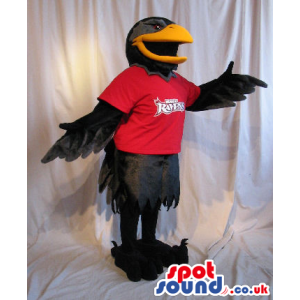 Black Bird Plush Mascot Wearing A Red T-Shirt With A Logo. -