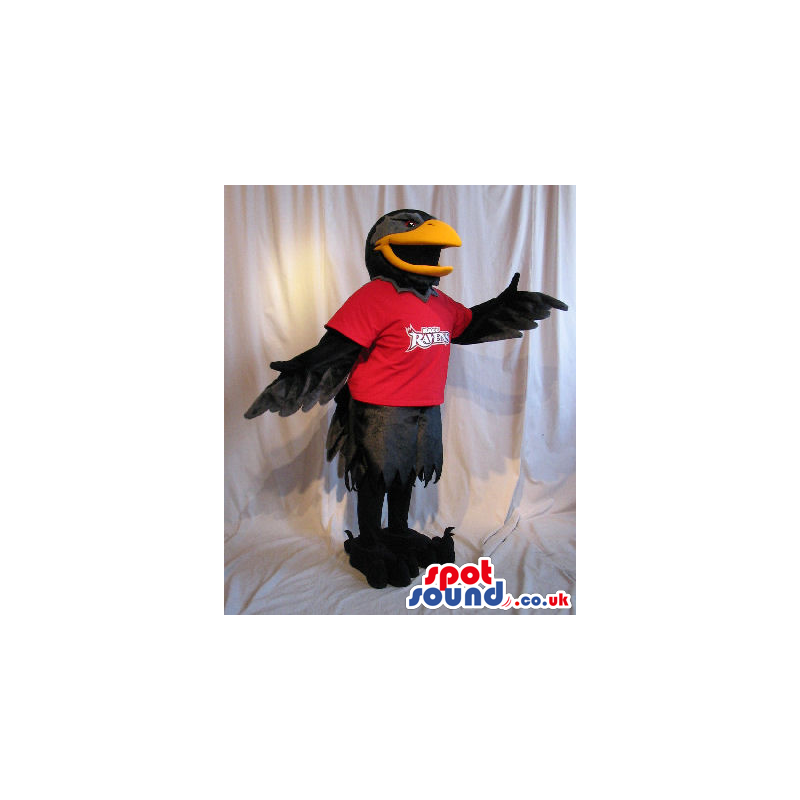 Black Bird Plush Mascot Wearing A Red T-Shirt With A Logo. -