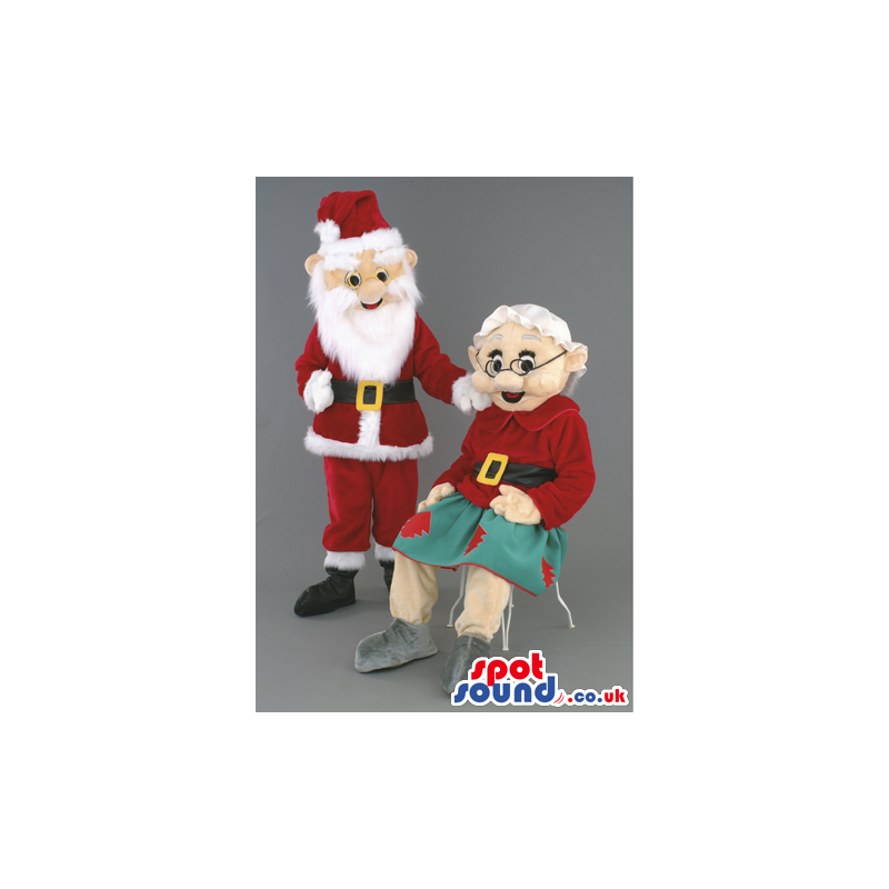 Mr and Mrs Claus mascot in traditional red santa outfil -