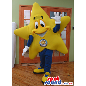 Happy Yellow Star Plush Mascot With A Logo Wearing Sneakers -